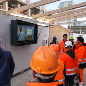 Morning meeting at the touch-enabled construction site signage